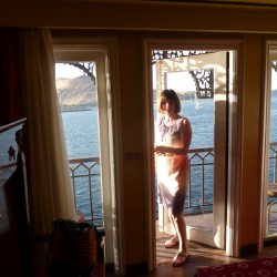 MS Misr. Barbara stepping out onto a cabin's balcony.